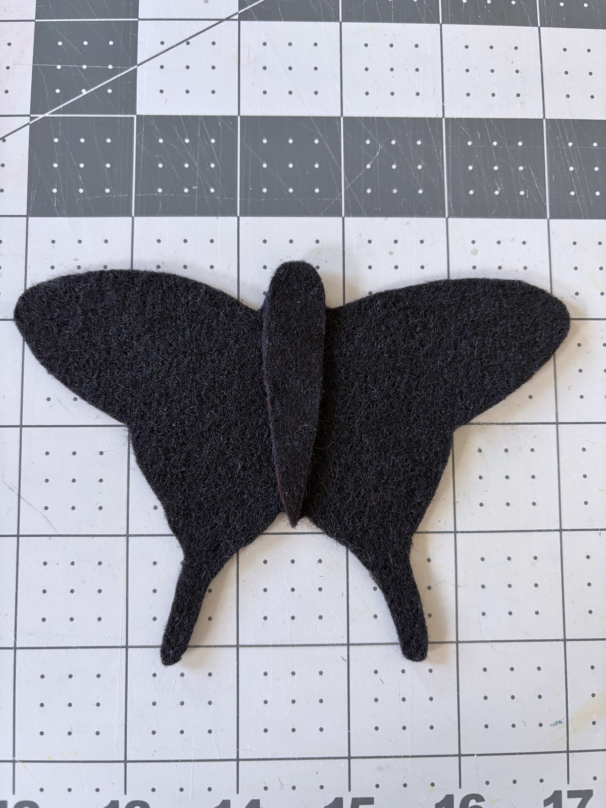 Butterfly body piece stacked on top of black base piece.