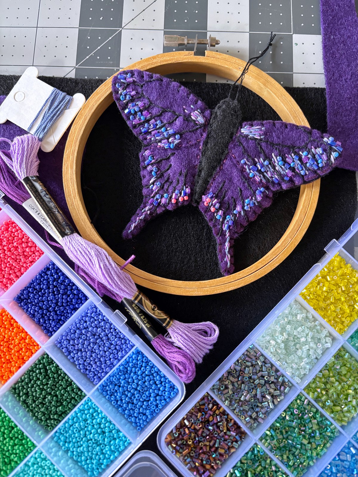 Finished purple butterfly ornament surrounded by sewing supplies.
