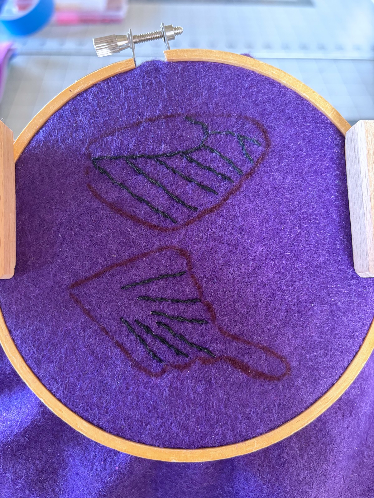Black embroidery details on wing pieces.