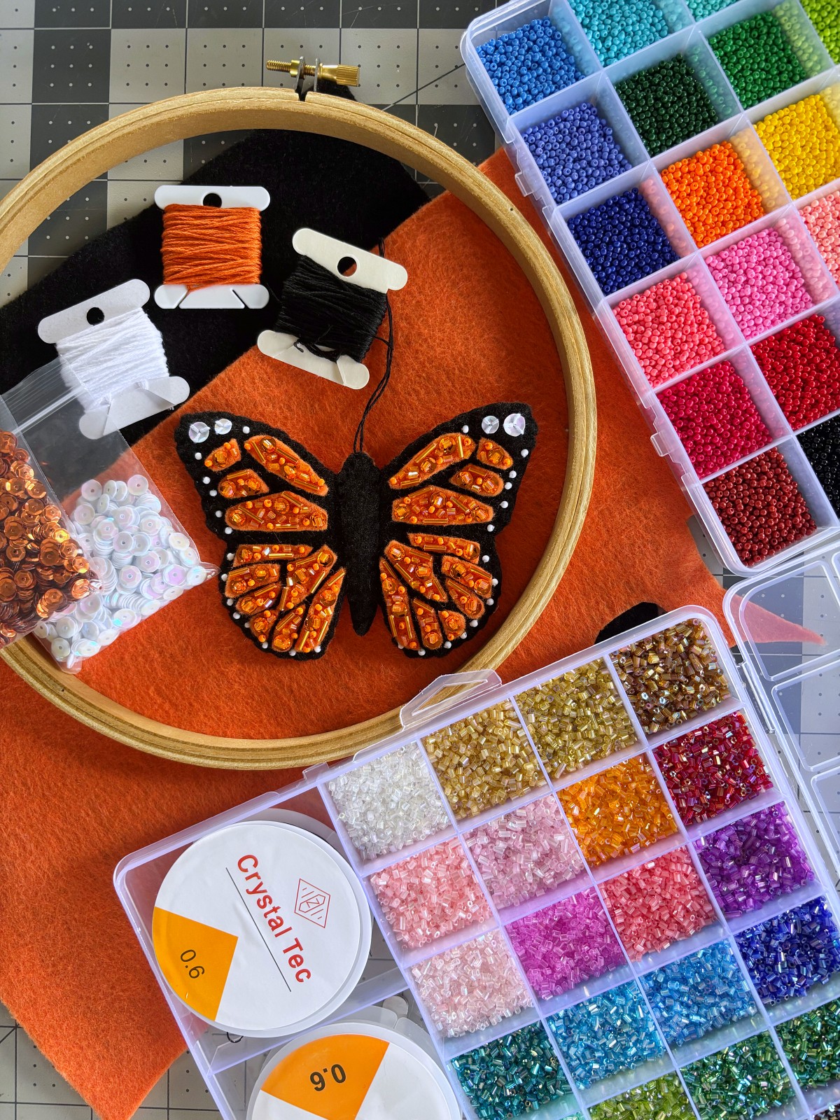 Finished Butterfly ornament surrounded by craft supplies.