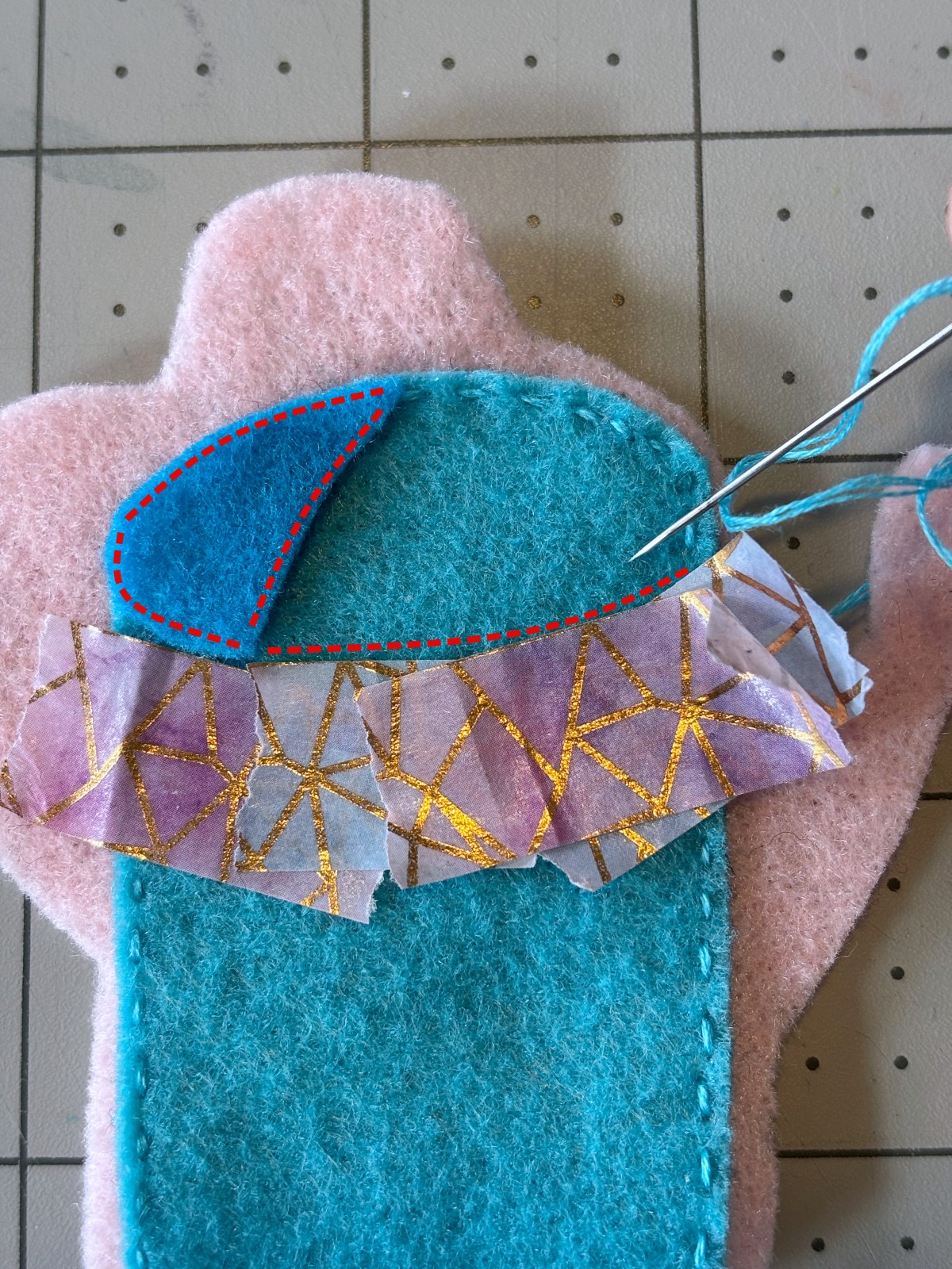 watering can ornament with top opening piece set in place and tape indicating where to sew.