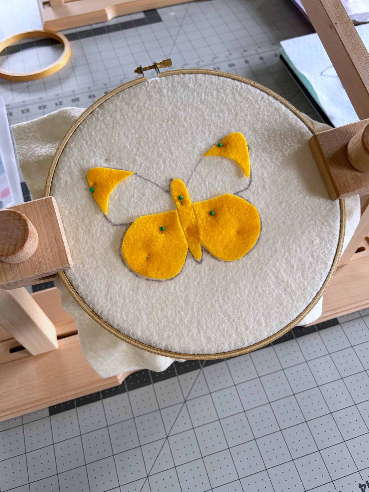 Dark yellow pattern pieces pined on the butterfly base.