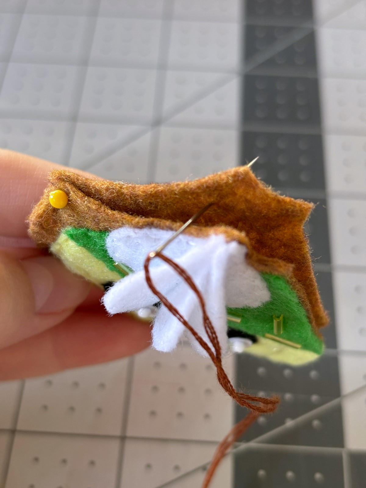 Starting a blanket stitch between the two pie base layers.