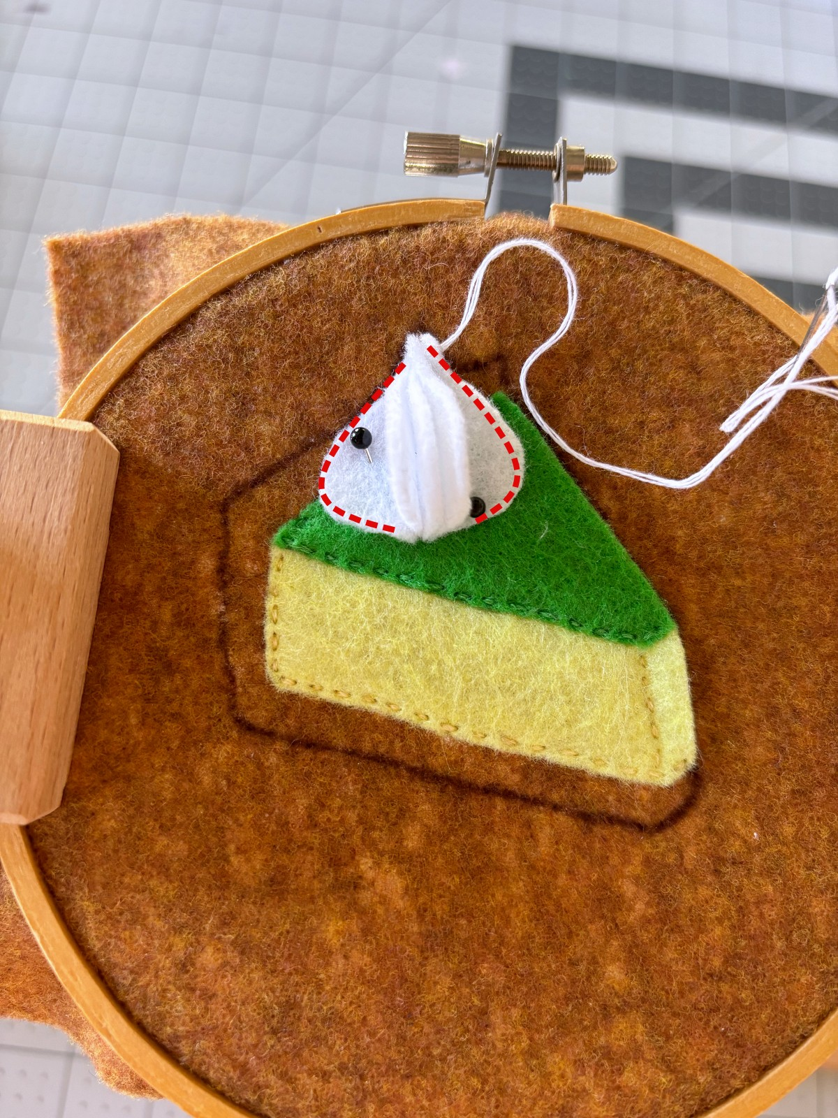 Frosting piece pined to pie base layer.