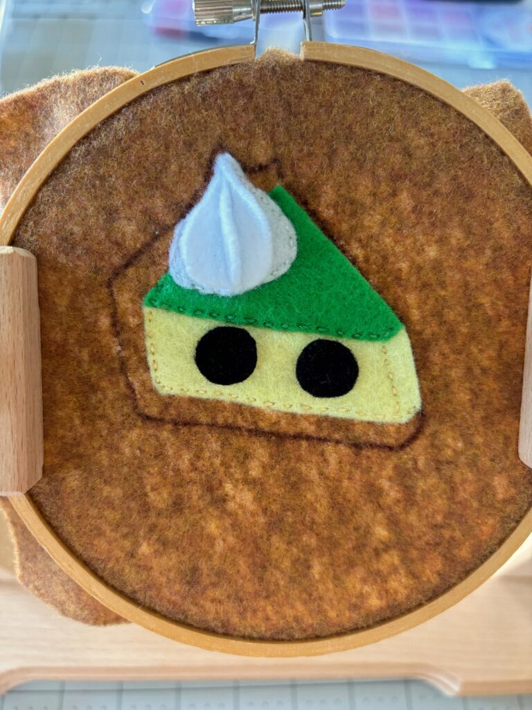 Placement of black eye pieces on pie base.