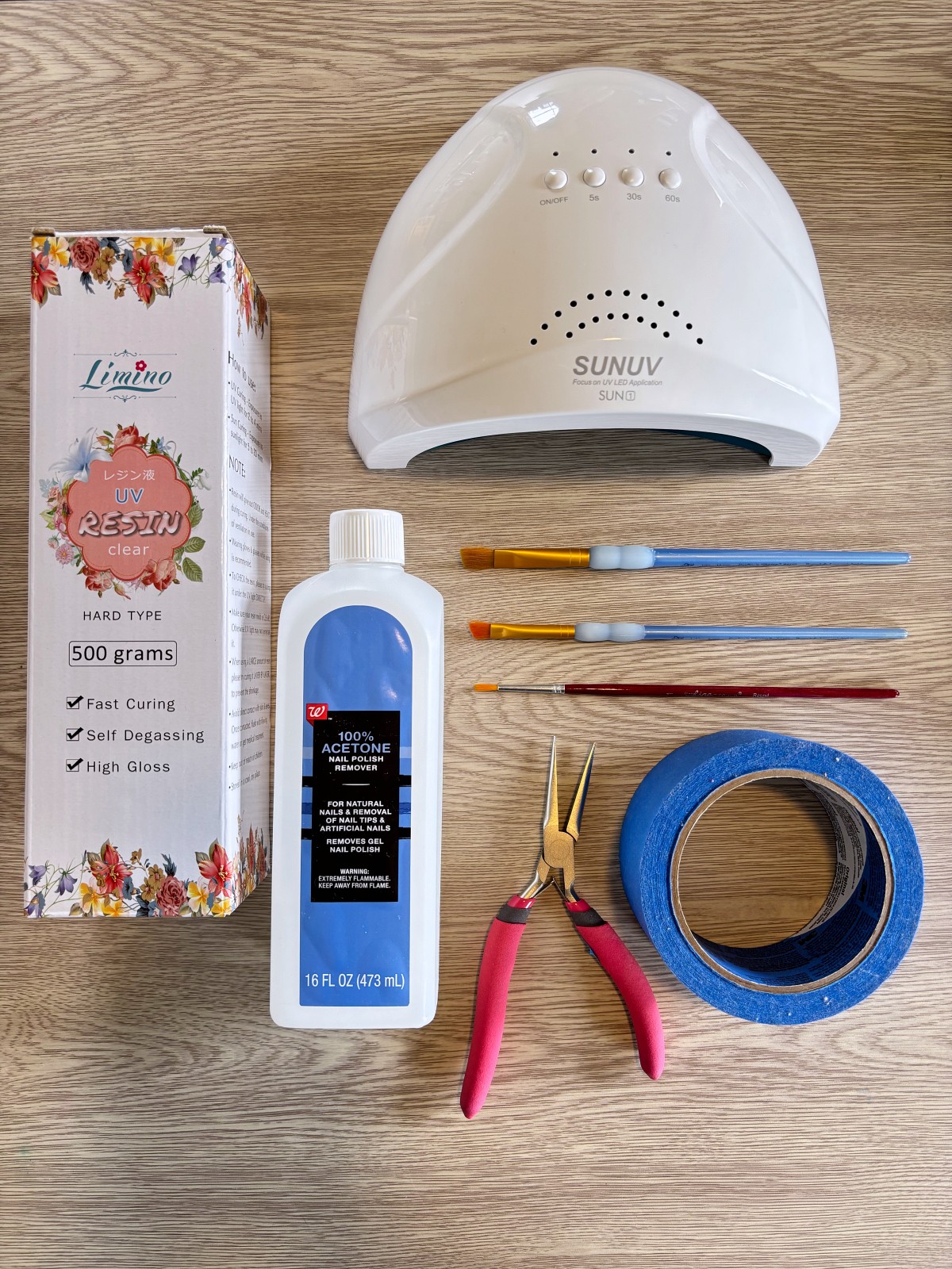 UV resin, UV nail lamp, pliers, acetone, tape, and paintbrushes.
