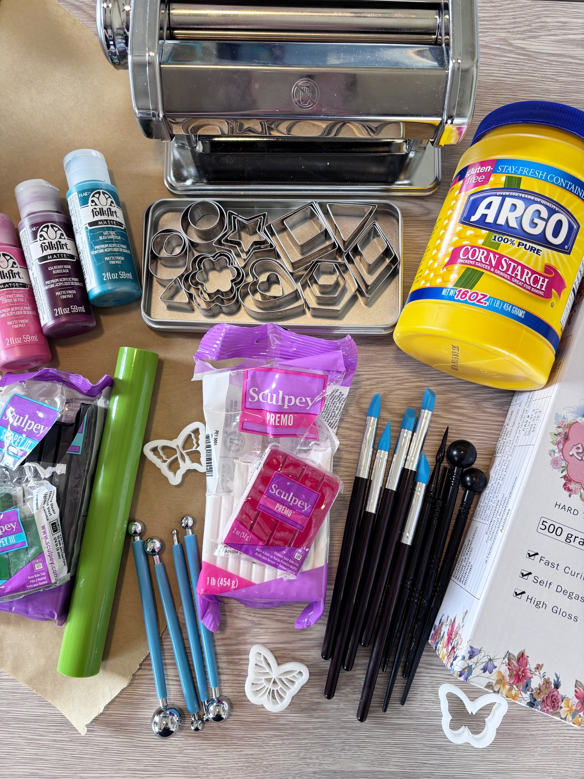 Polymer clay tools and supplies on a table.