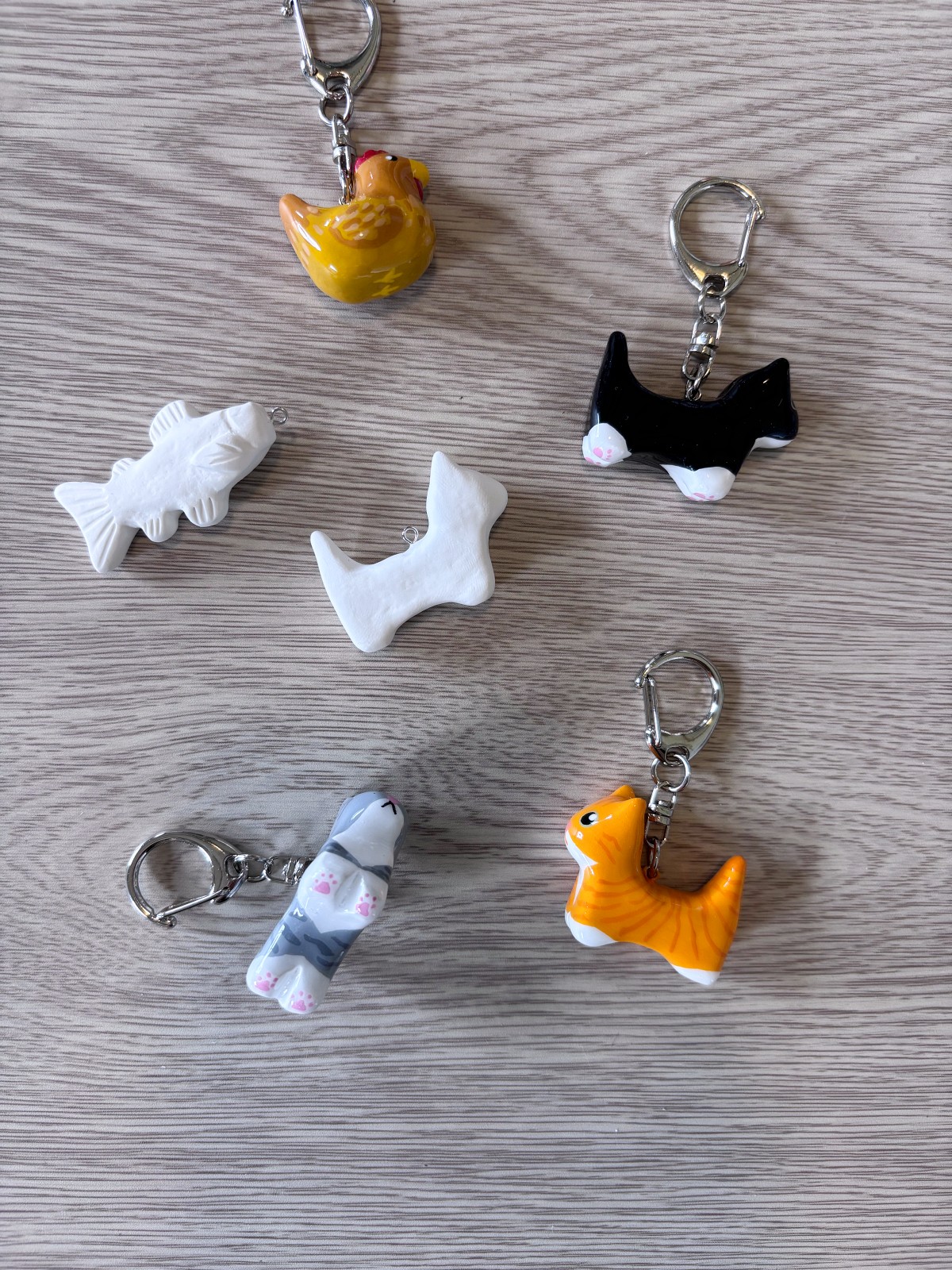 Polymer clay animal charms including cats, fish and chicken.