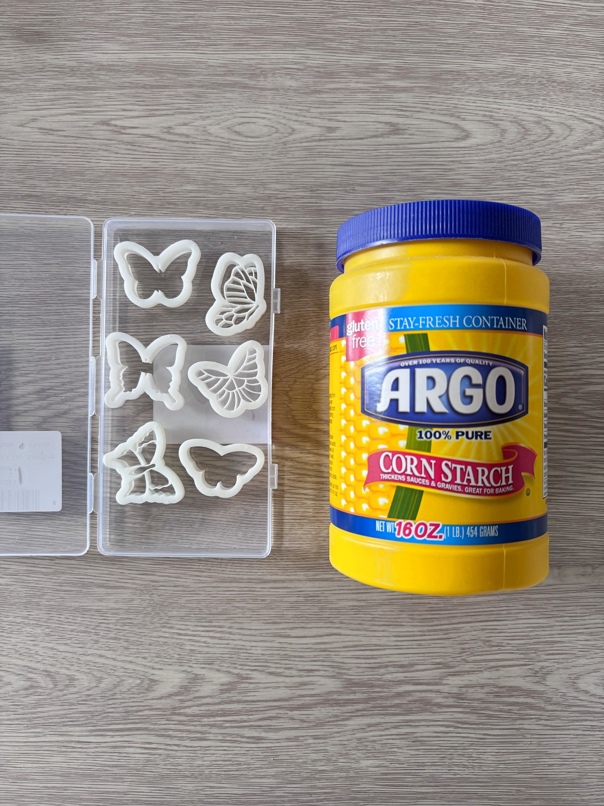 Corn starch bottle next to butterfly cutters.