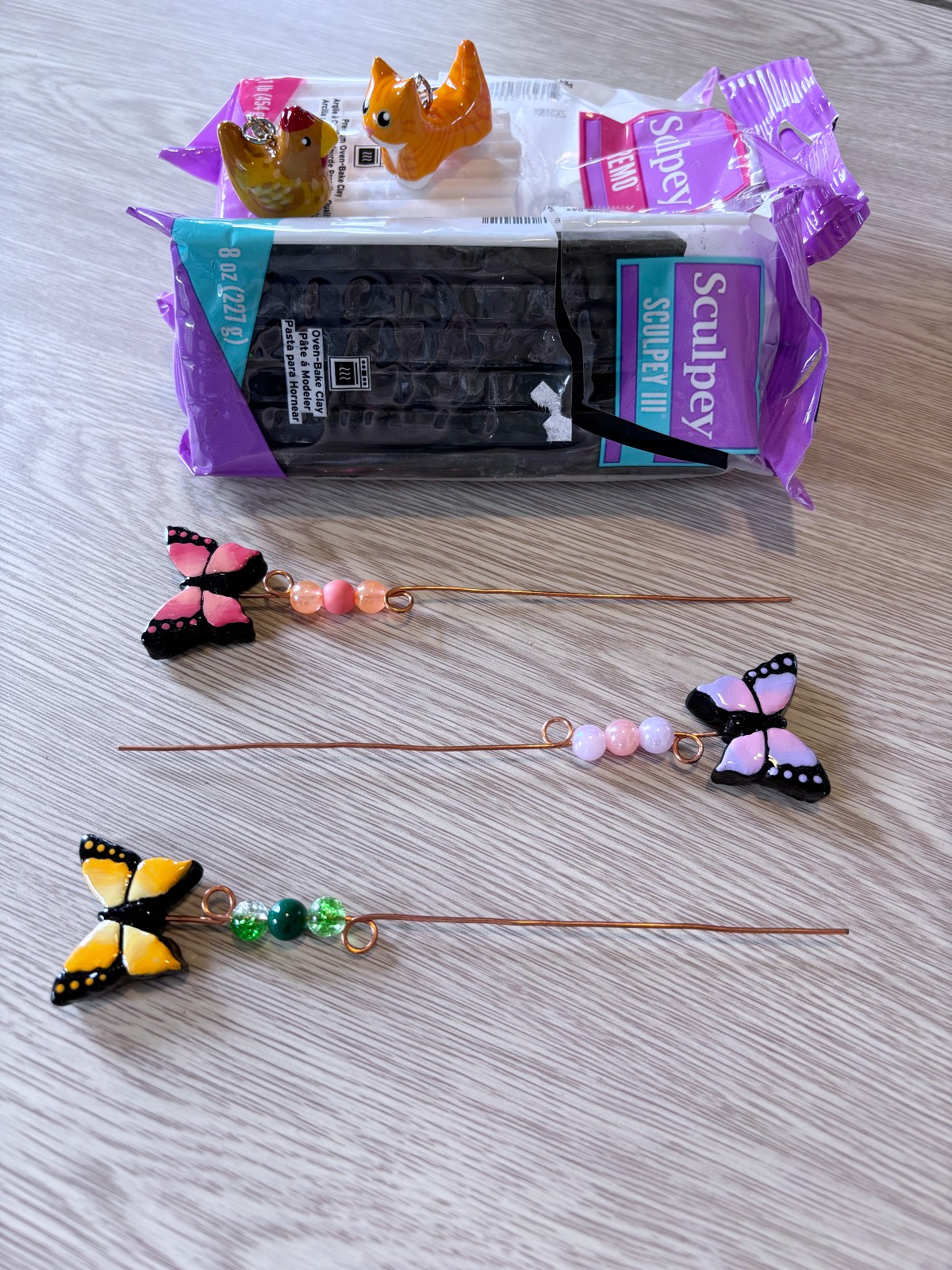 Polymer clay, clay charms, and plant sticks.