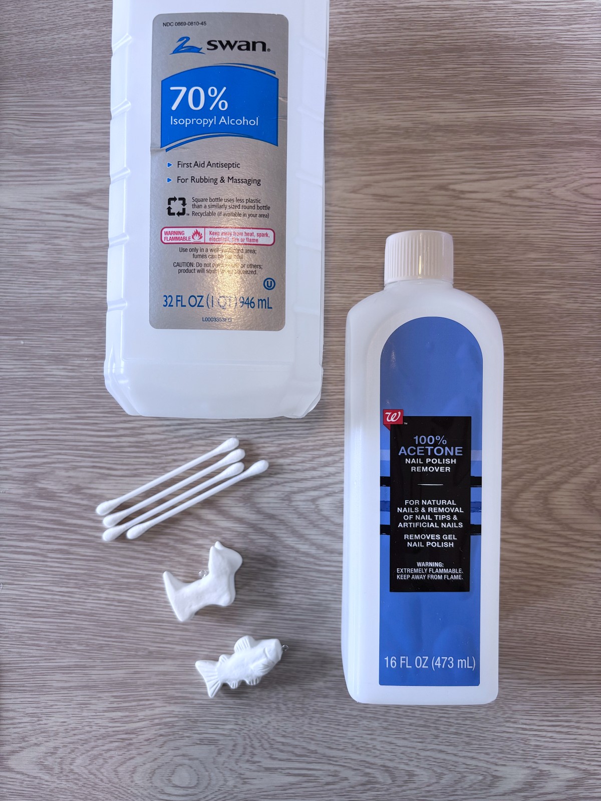 Isopropyl Alcohol, 100% Acetone, Cotton swabs, and clay charms.