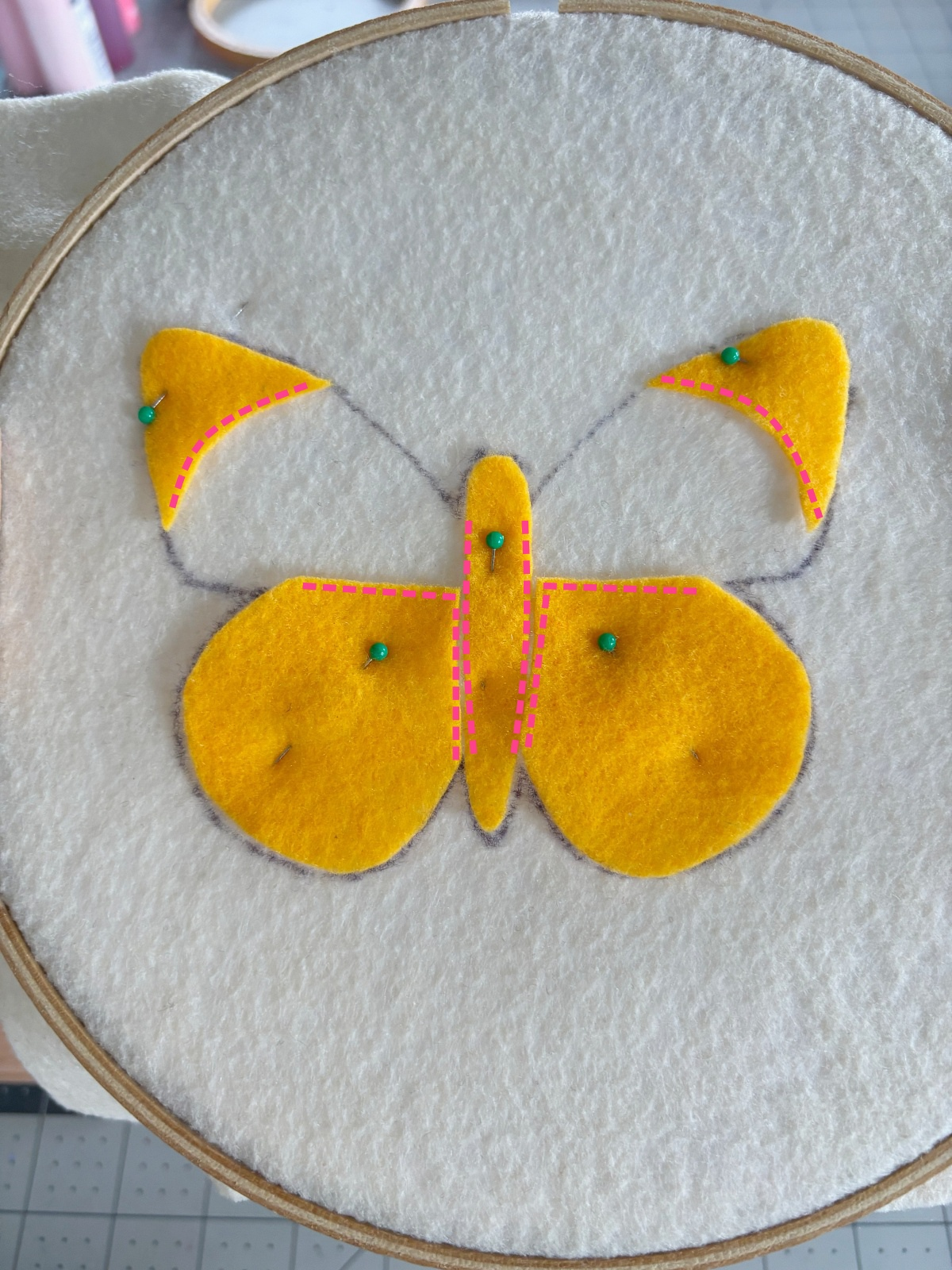pink dotted lines on the butterfly base indicating where to sew.
