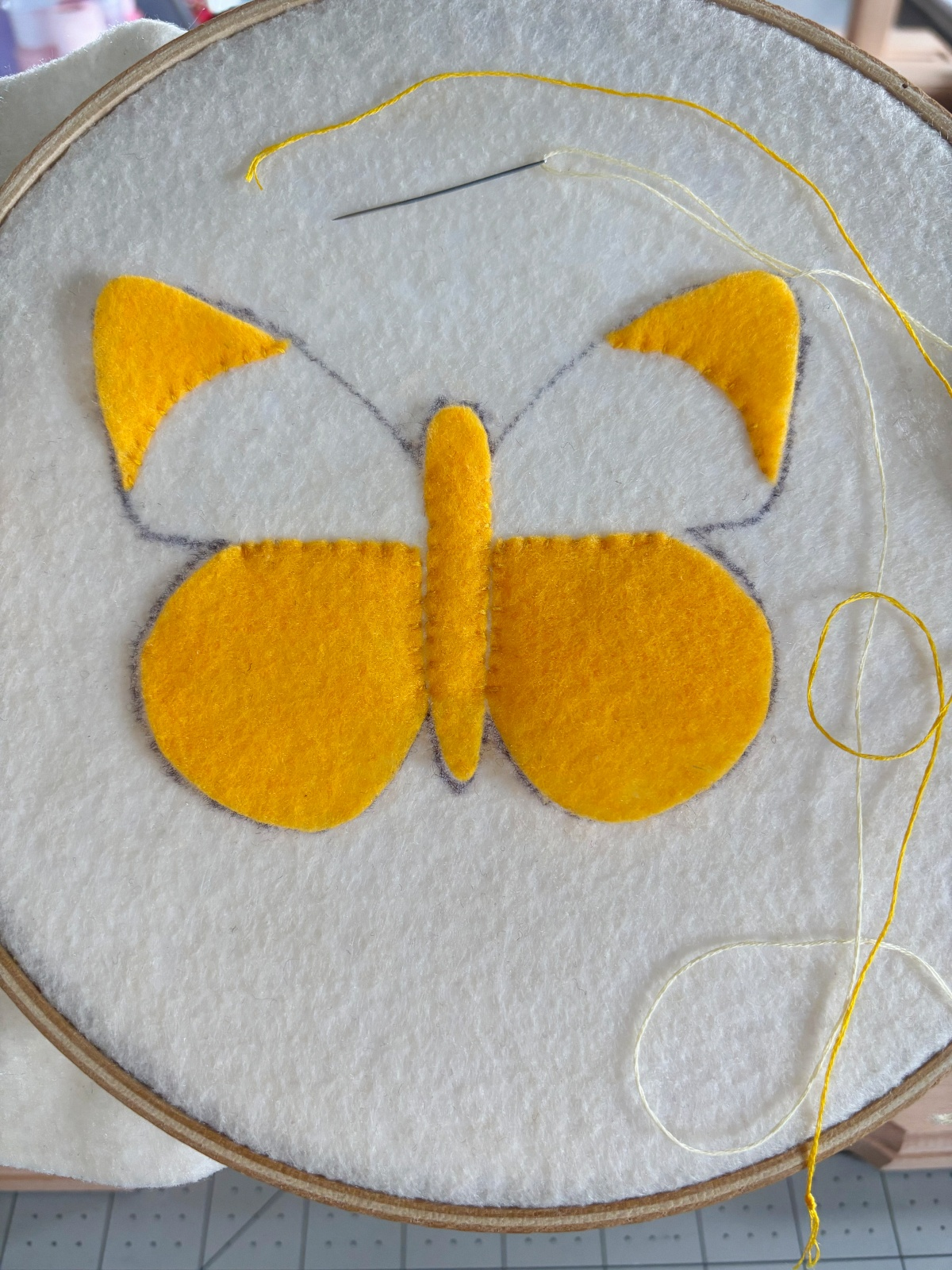 Butterfly base with yellow pattern pieces sewn on.