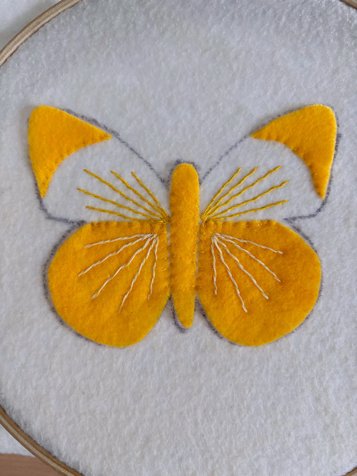 Butterfly embroidery details sewn on the wings.