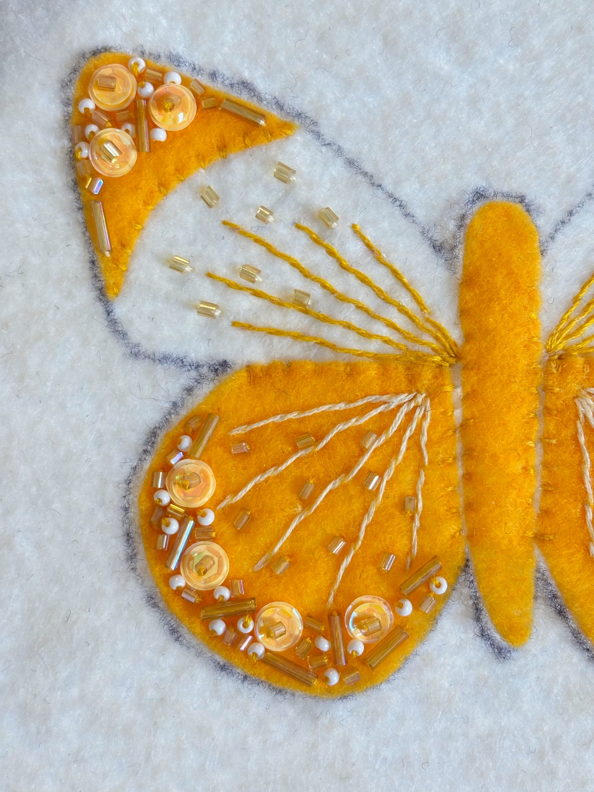 Close up of wing sequin and bead details.