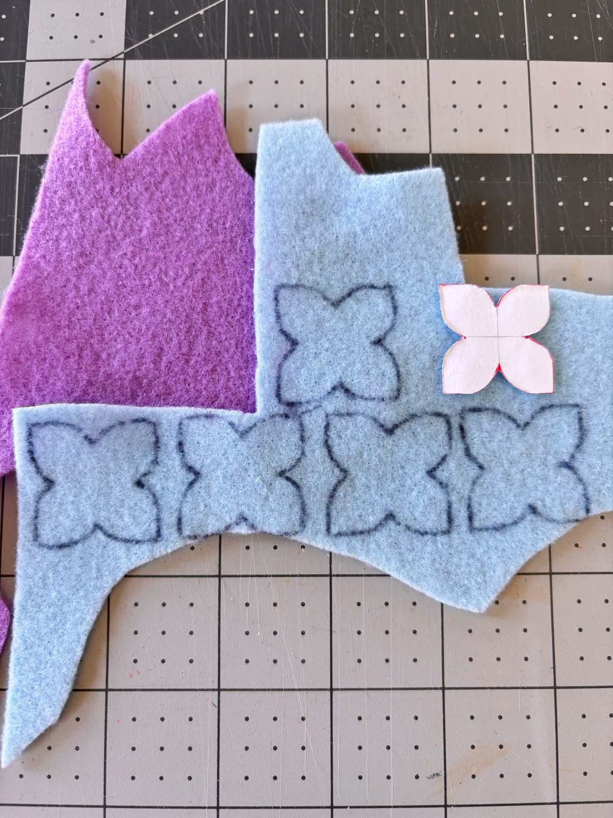 Paper flower pattern traced onto felt with a pen.