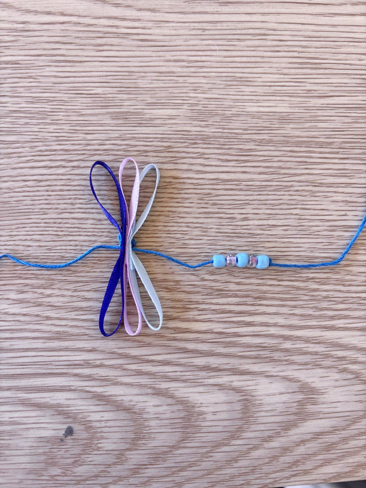 First section of beads and ribbon threaded onto the embroidery thread.