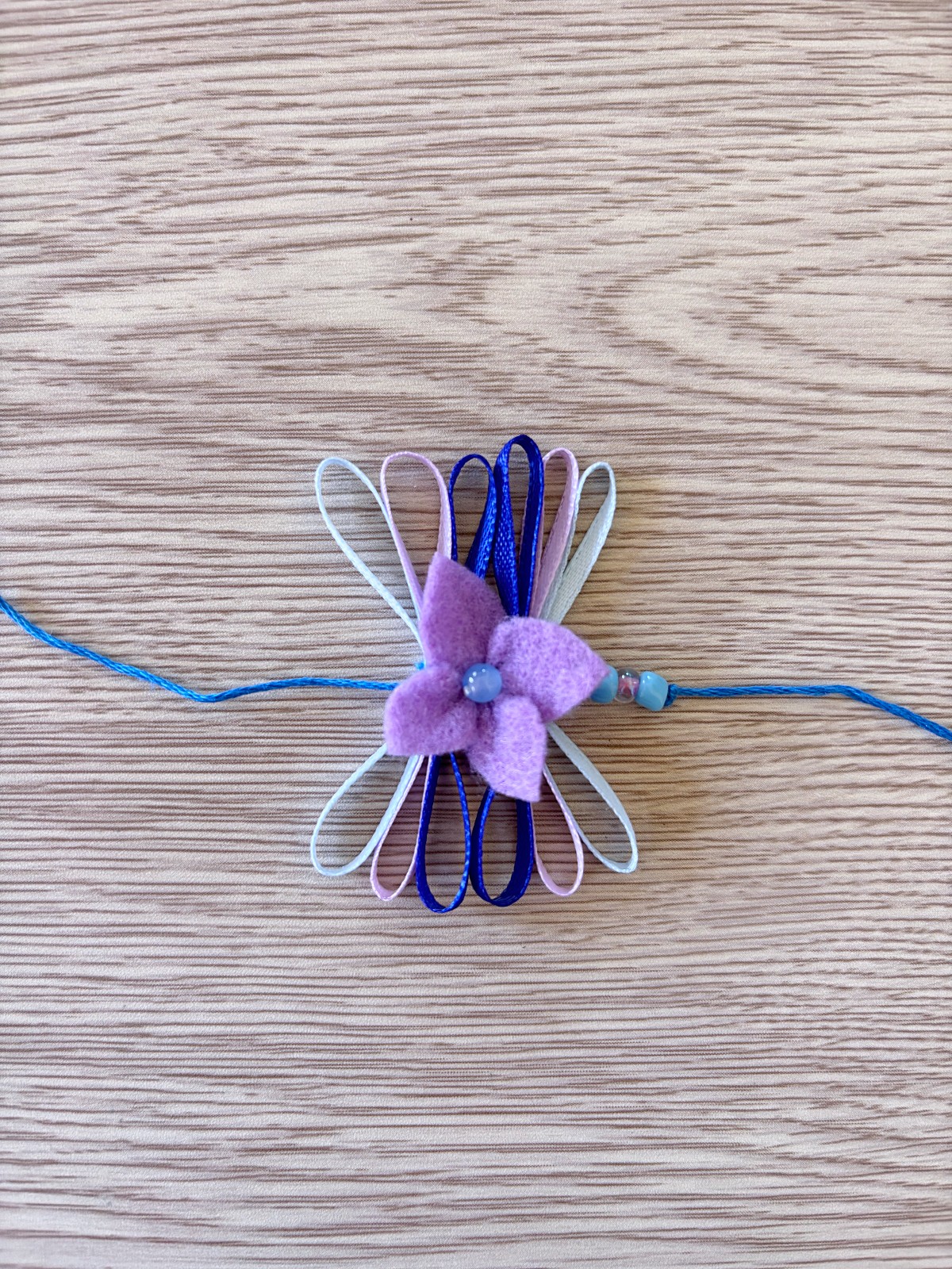 Adding a flower and ribbon section to the flower crown embroidery thread.