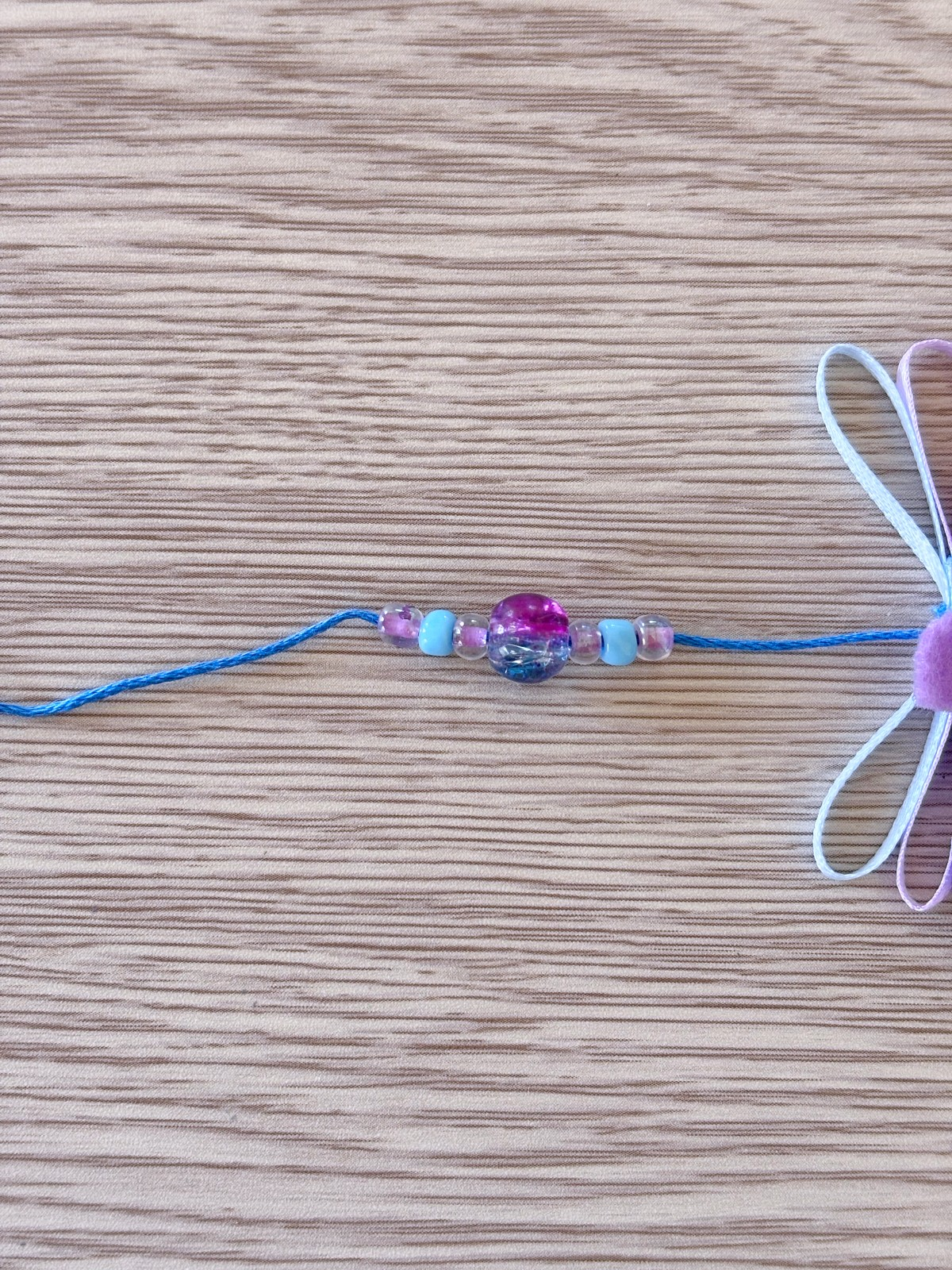 Threading on the beaded pattern onto the embroidery thread.