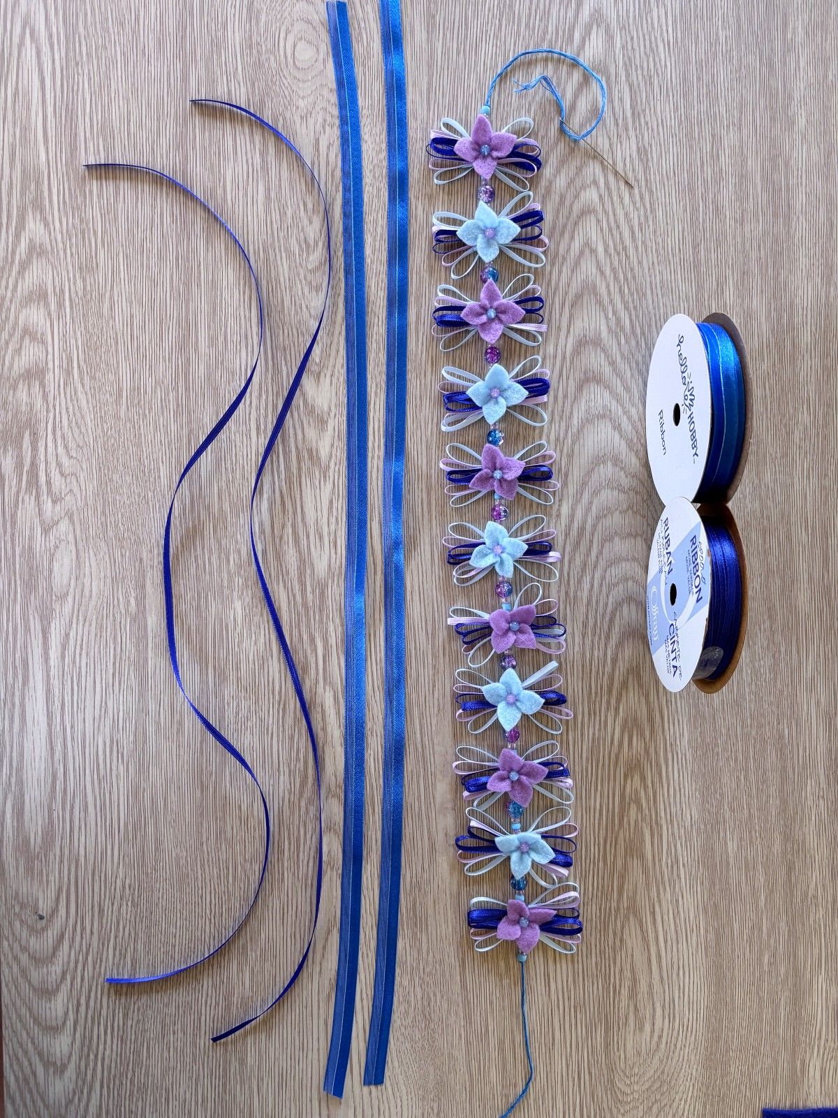 Flower crown and ribbon ties on a table.