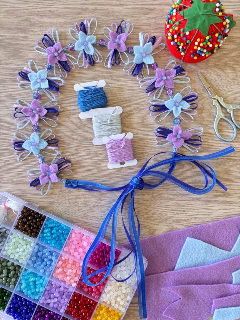 Flower crown and sewing materials on a table.