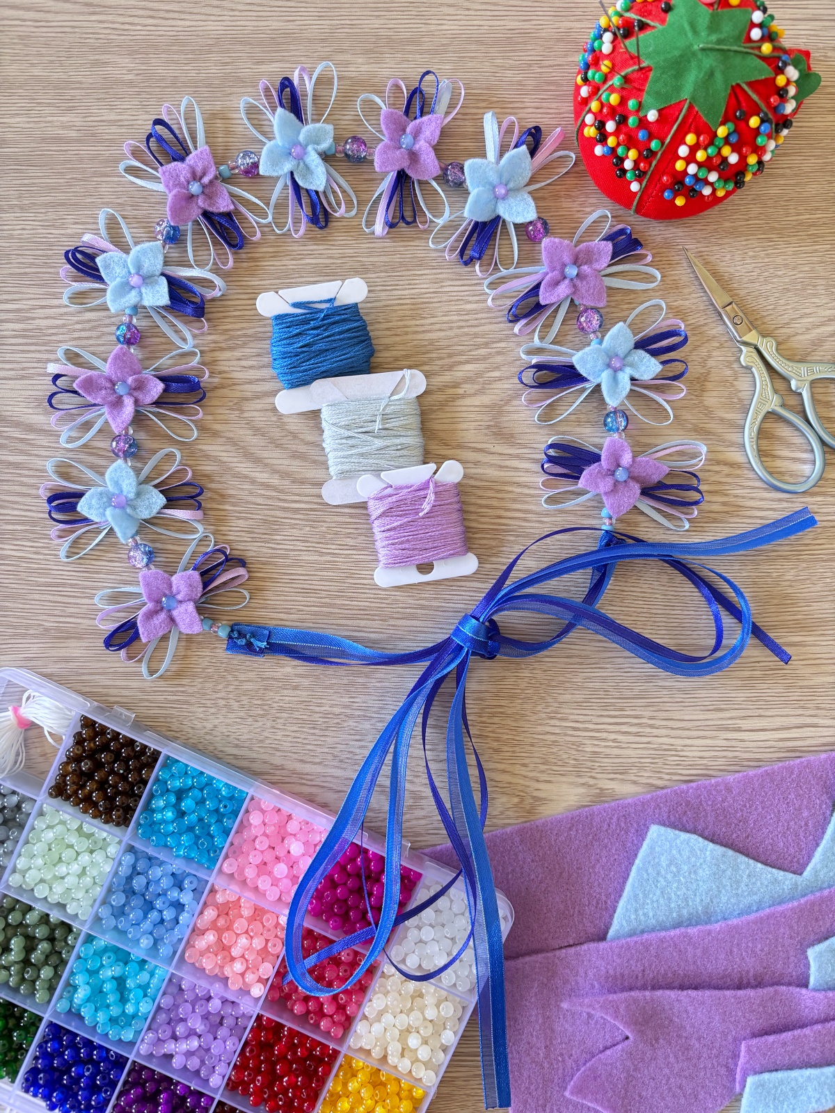 Flower crown and sewing materials on a table.