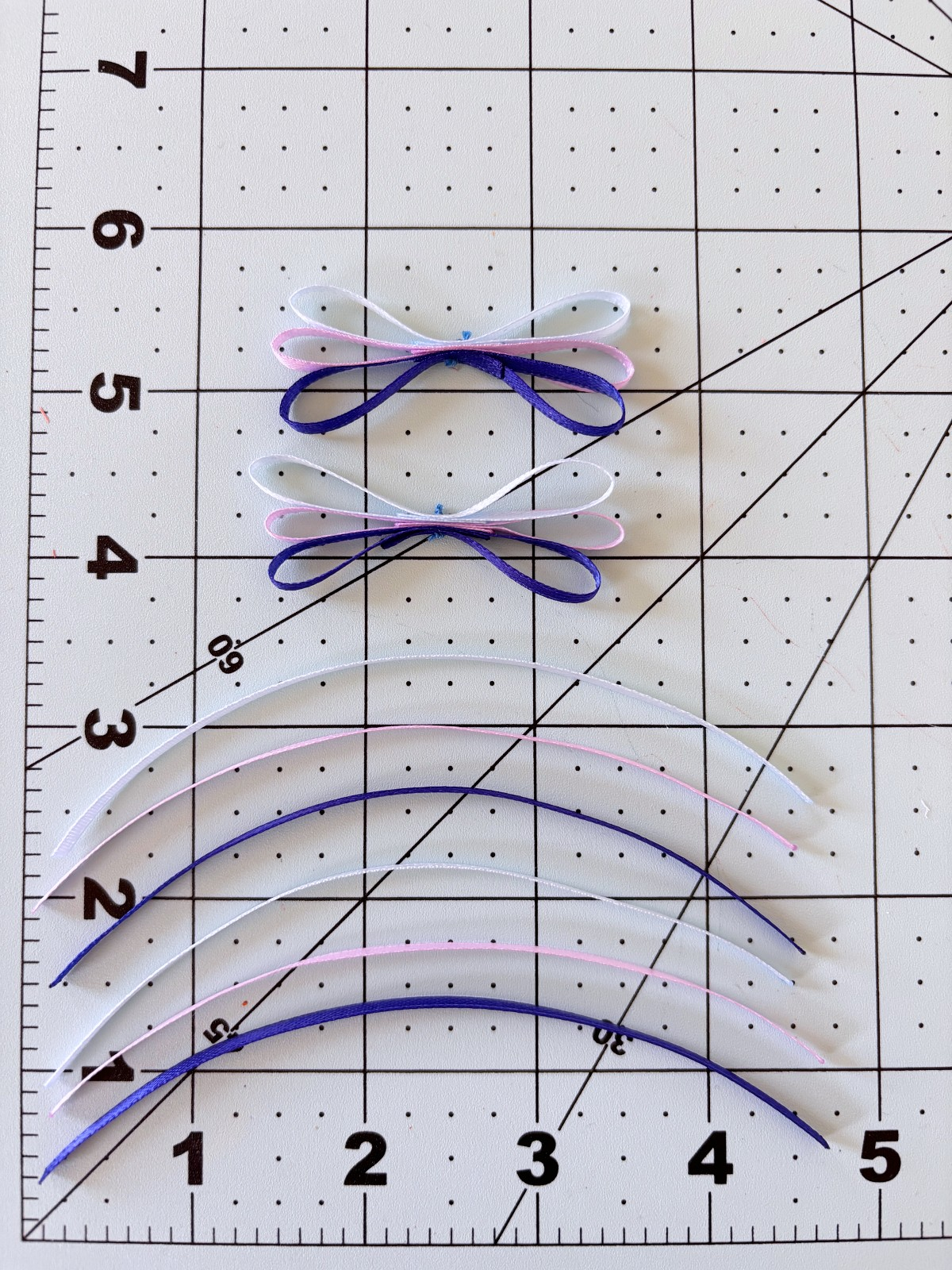 Ribbon strands cut into five inch long strips on a table.