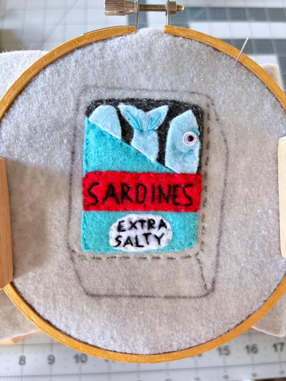 Sardine can ornament with all embroidery elements finished.