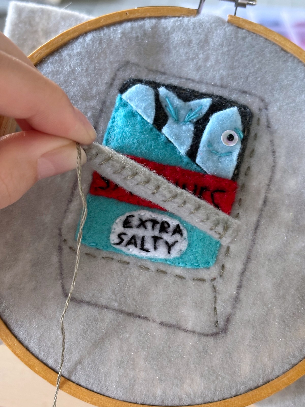 Whip stitch sewn along the rolled lid felt piece.