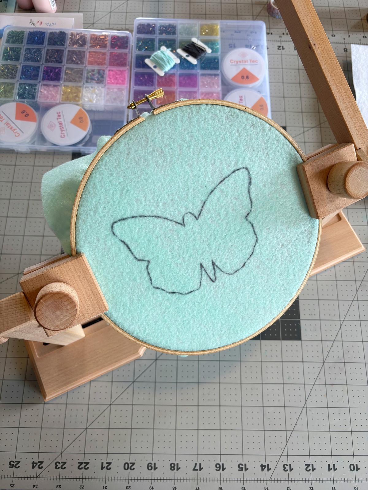 Butterfly base pattern piece in an embroidery hoop.