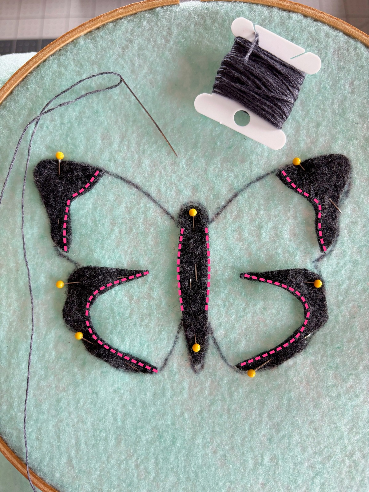Pink dotted lines showing where to sew on the gray wing details.