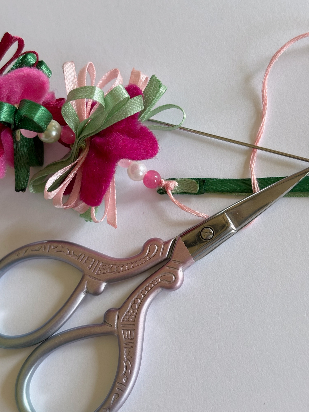 Knot on the back of ribbon ties ready to be cut.