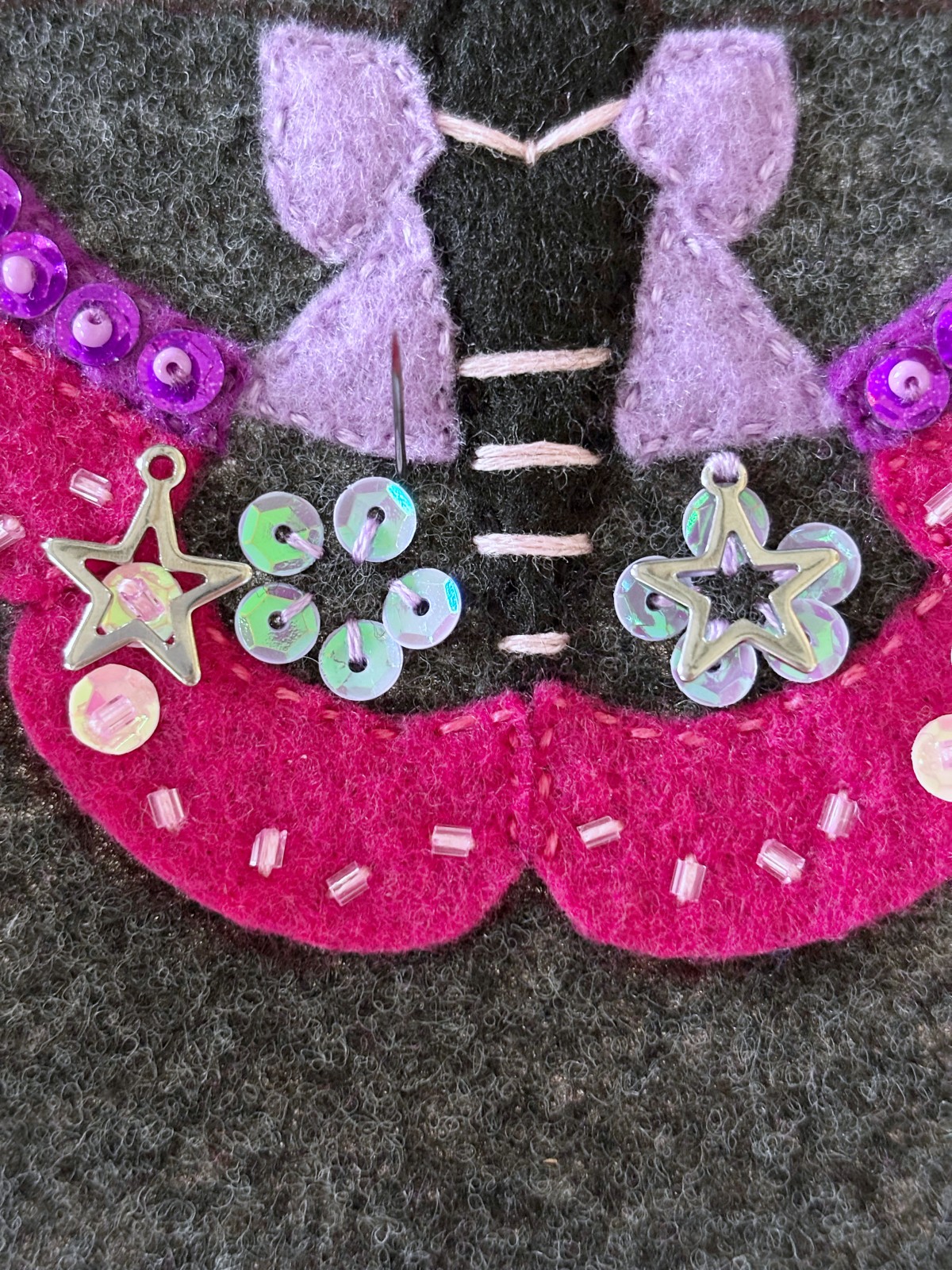 Metal star charms tack sewn to bottom moth wings.
