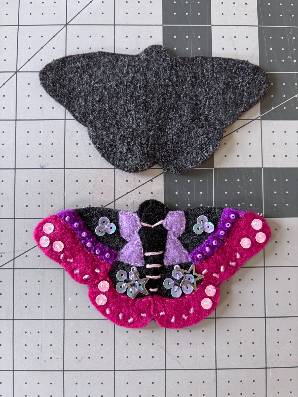 Both moth base felt pieces cut out on a table.