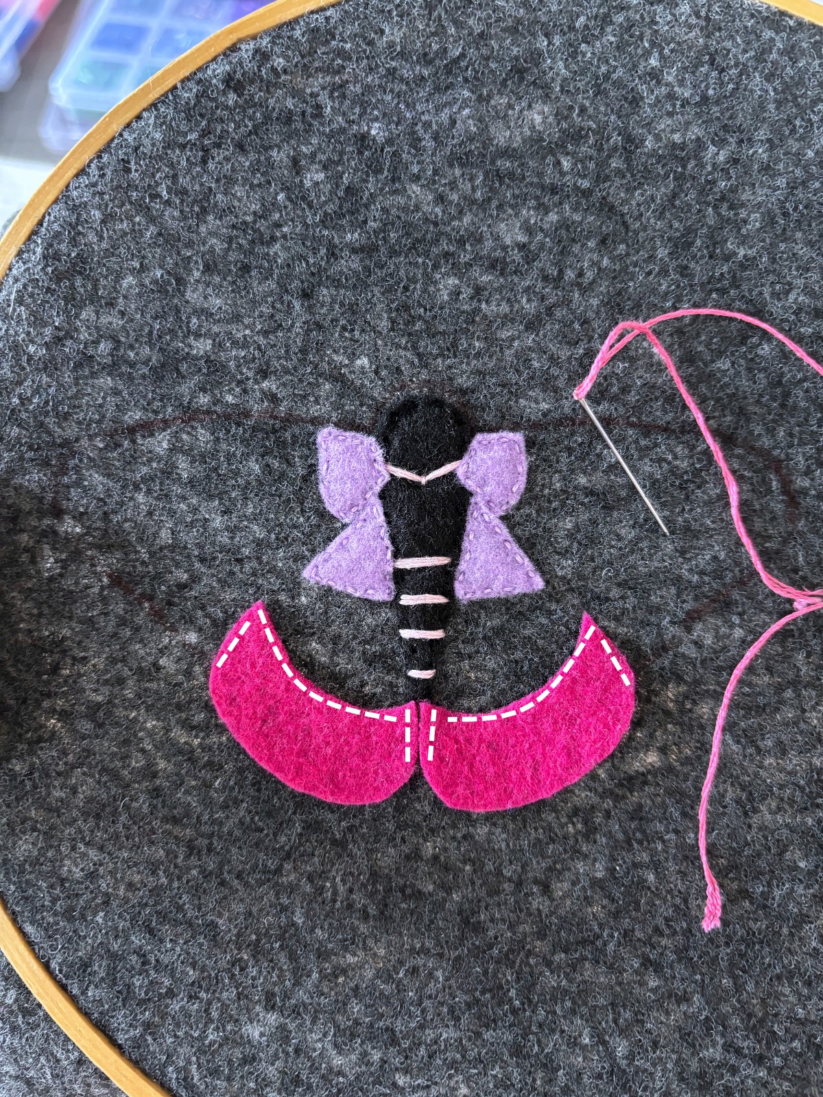Dark pink lower moth wing felt pieces with instructional sewing lines to follow.
