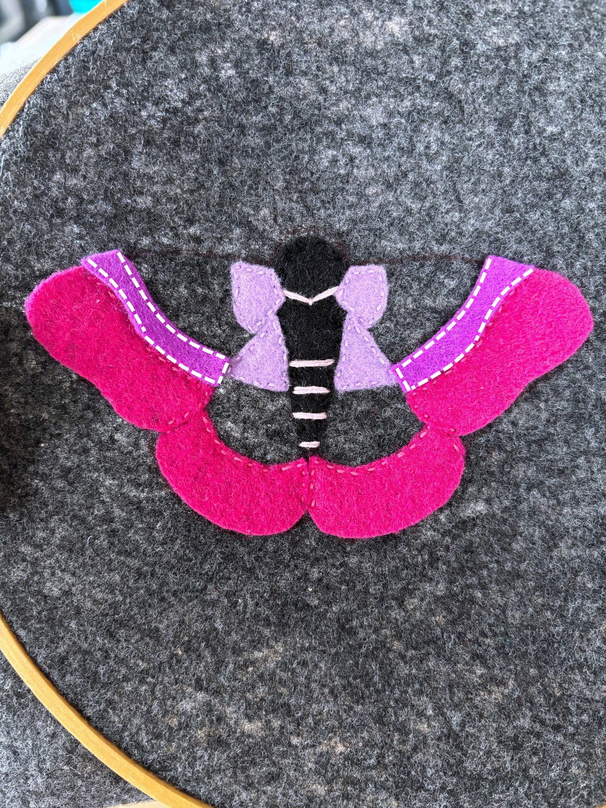 Dark purple upper moth wing felt pieces with instructional sewing lines to follow.
