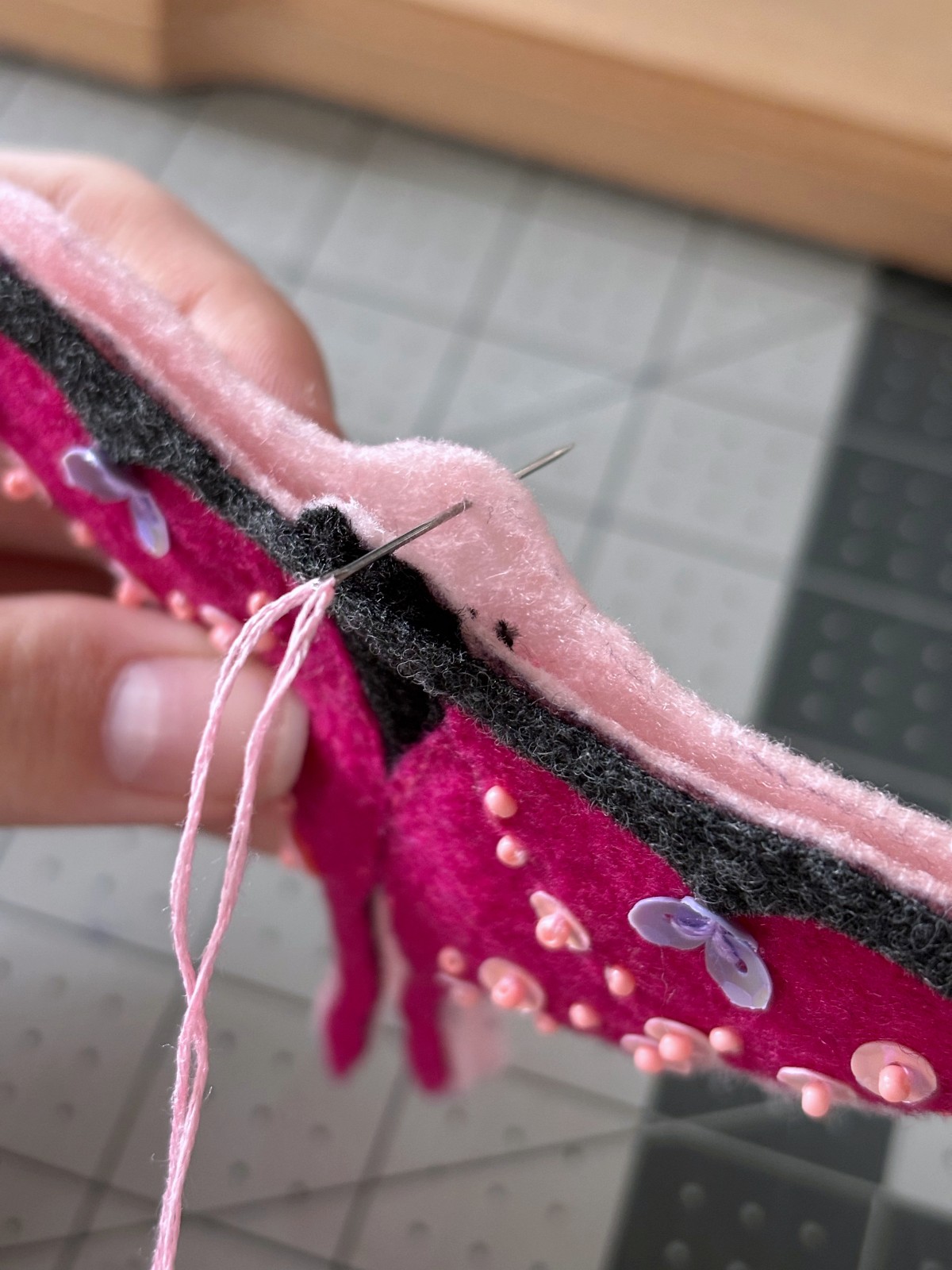 Both pink base pieces of the moth ornament pined together.